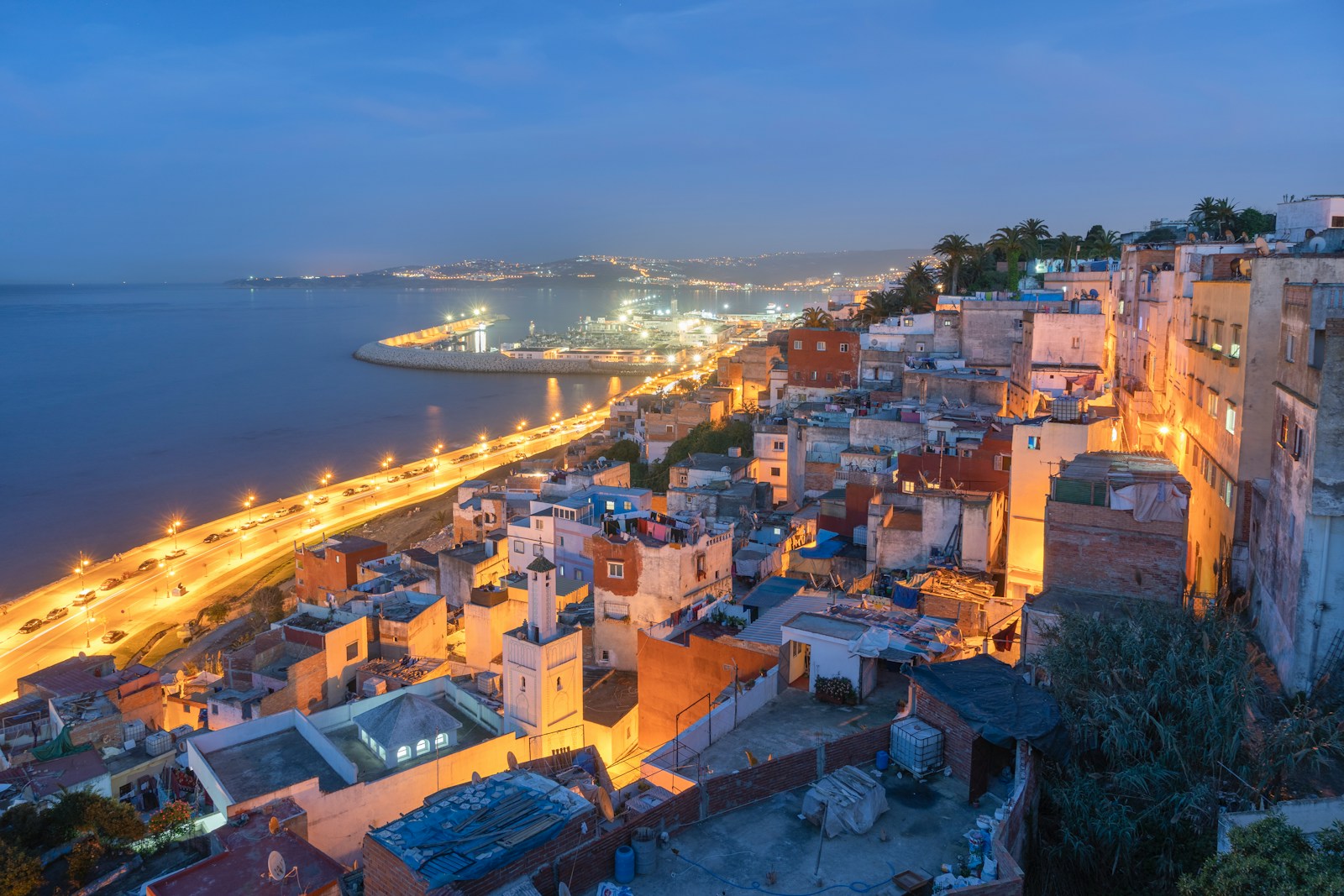 aerial view of Tangier city near body of water during night time - Tours from Tangier